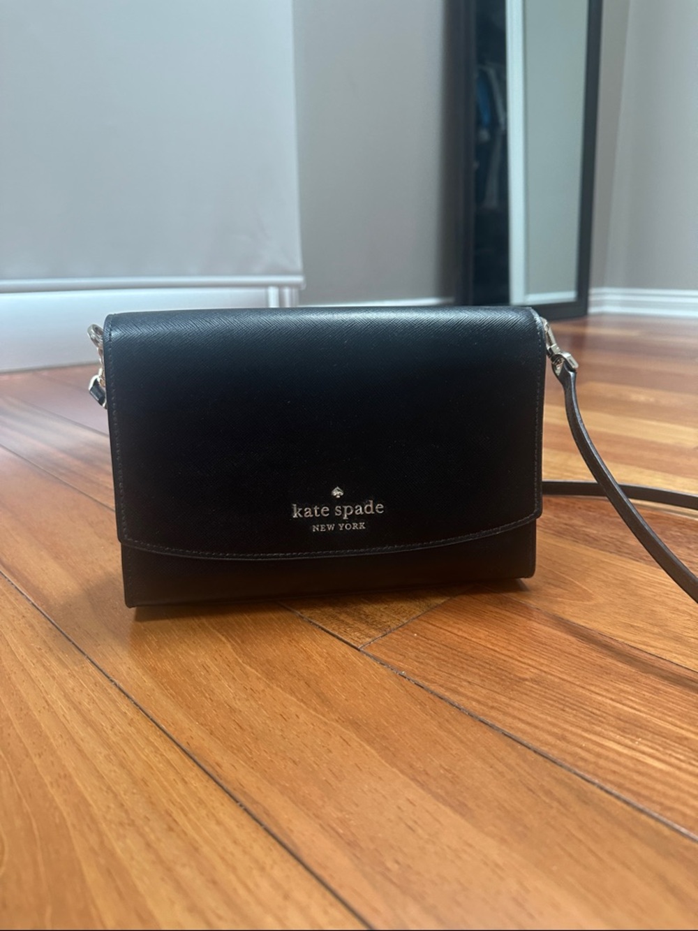 kate spade black leather crossbody with silver logo plaque